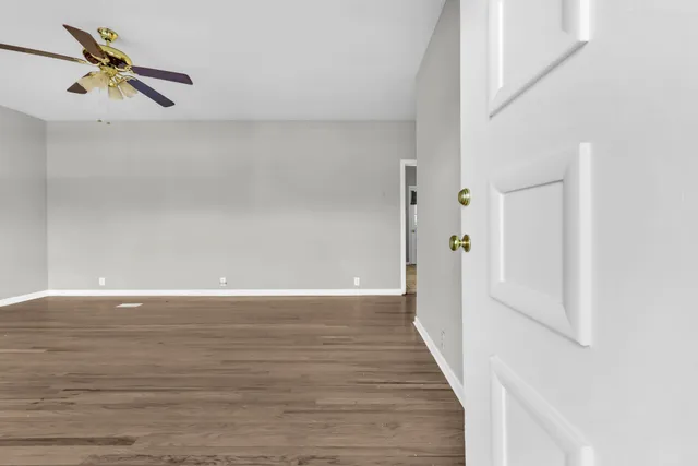 a view of a hallway with wooden floor