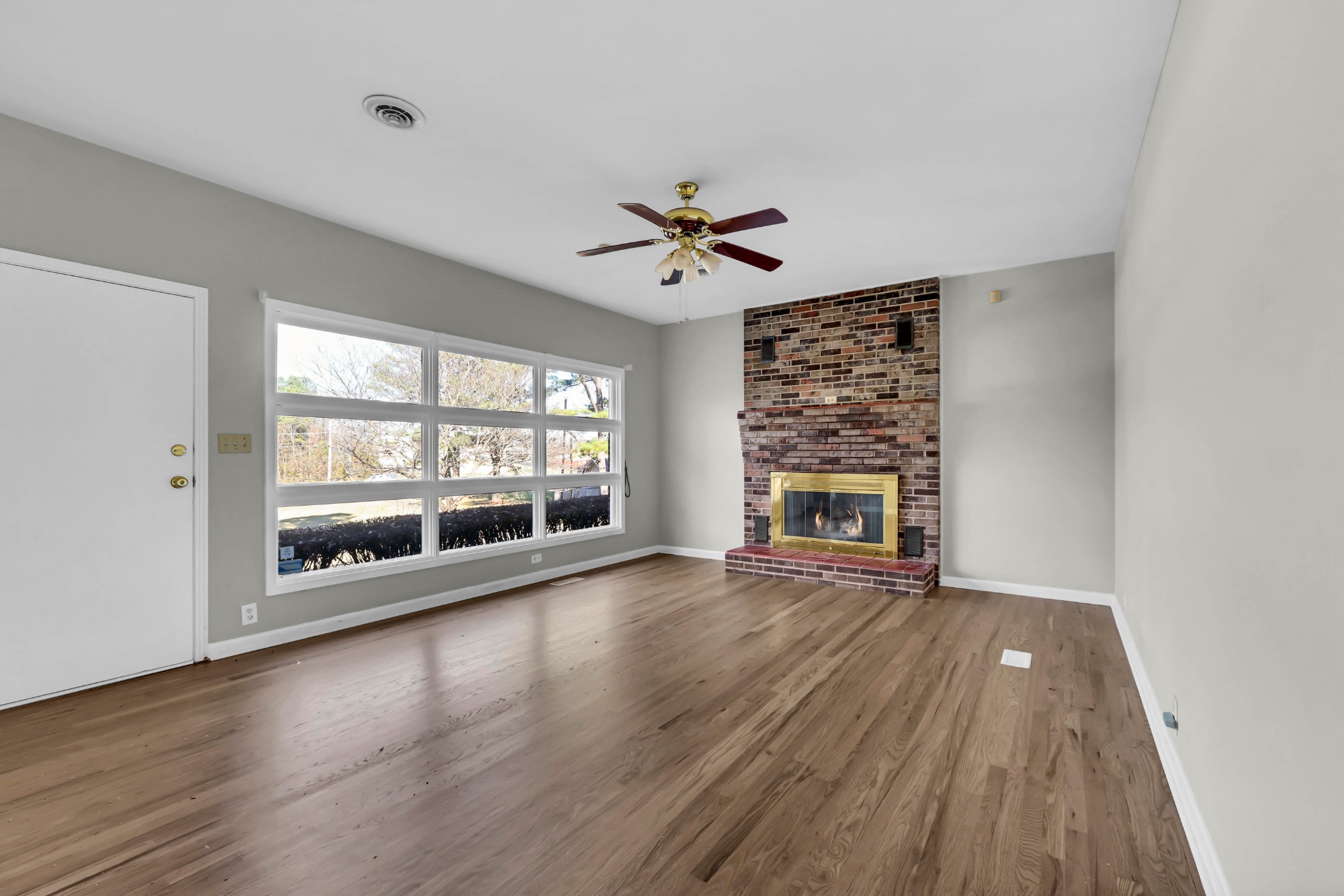 780 Rossview Road Clarksville, TN 37043 - Photo 10 of 40 a view of an empty room with a window and wooden floor
