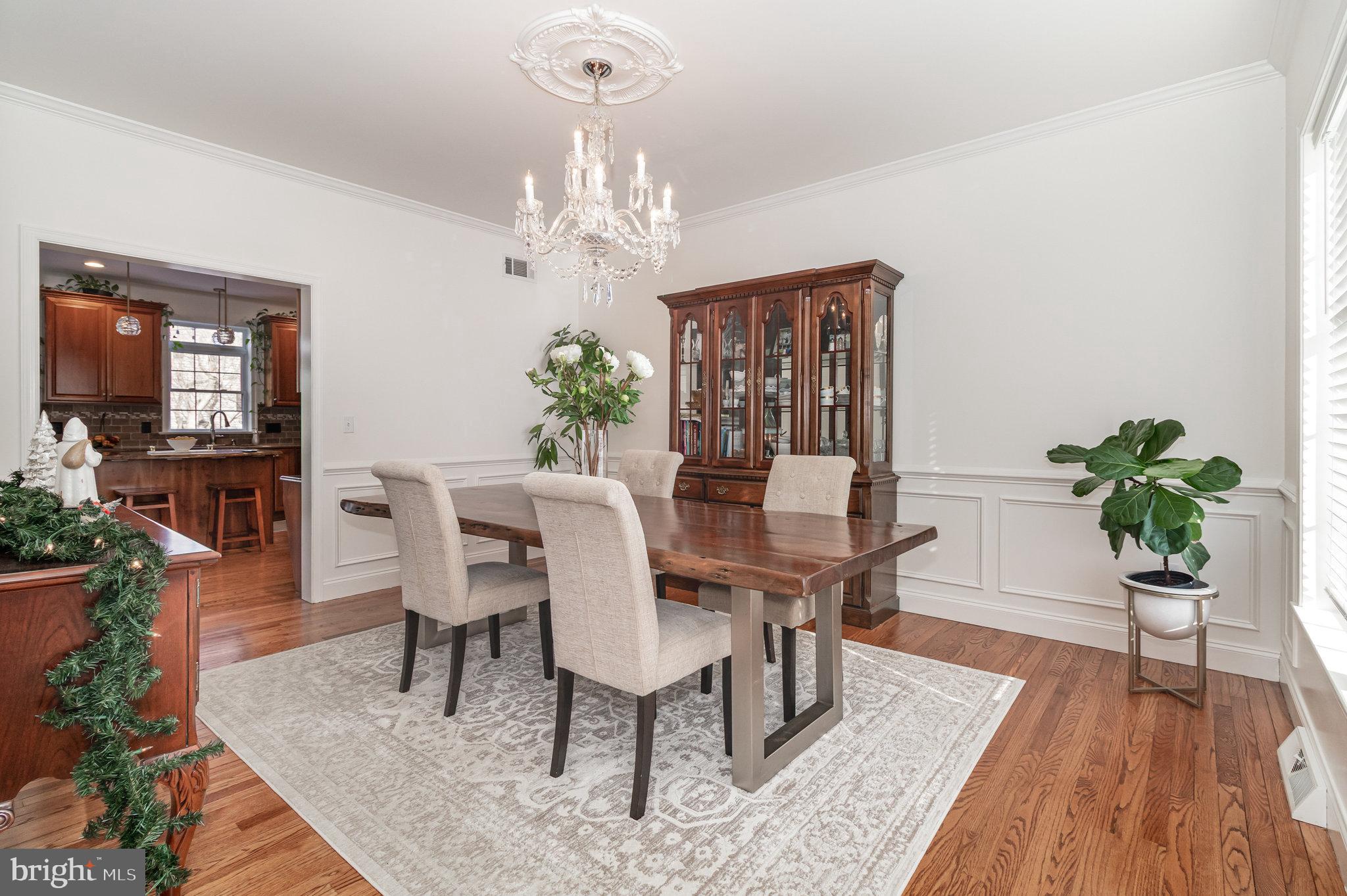 123 Glebe Lane Lancaster, PA 17602 - Photo 11 of 57 a view of a dining room with furniture a chandelier and wooden floor