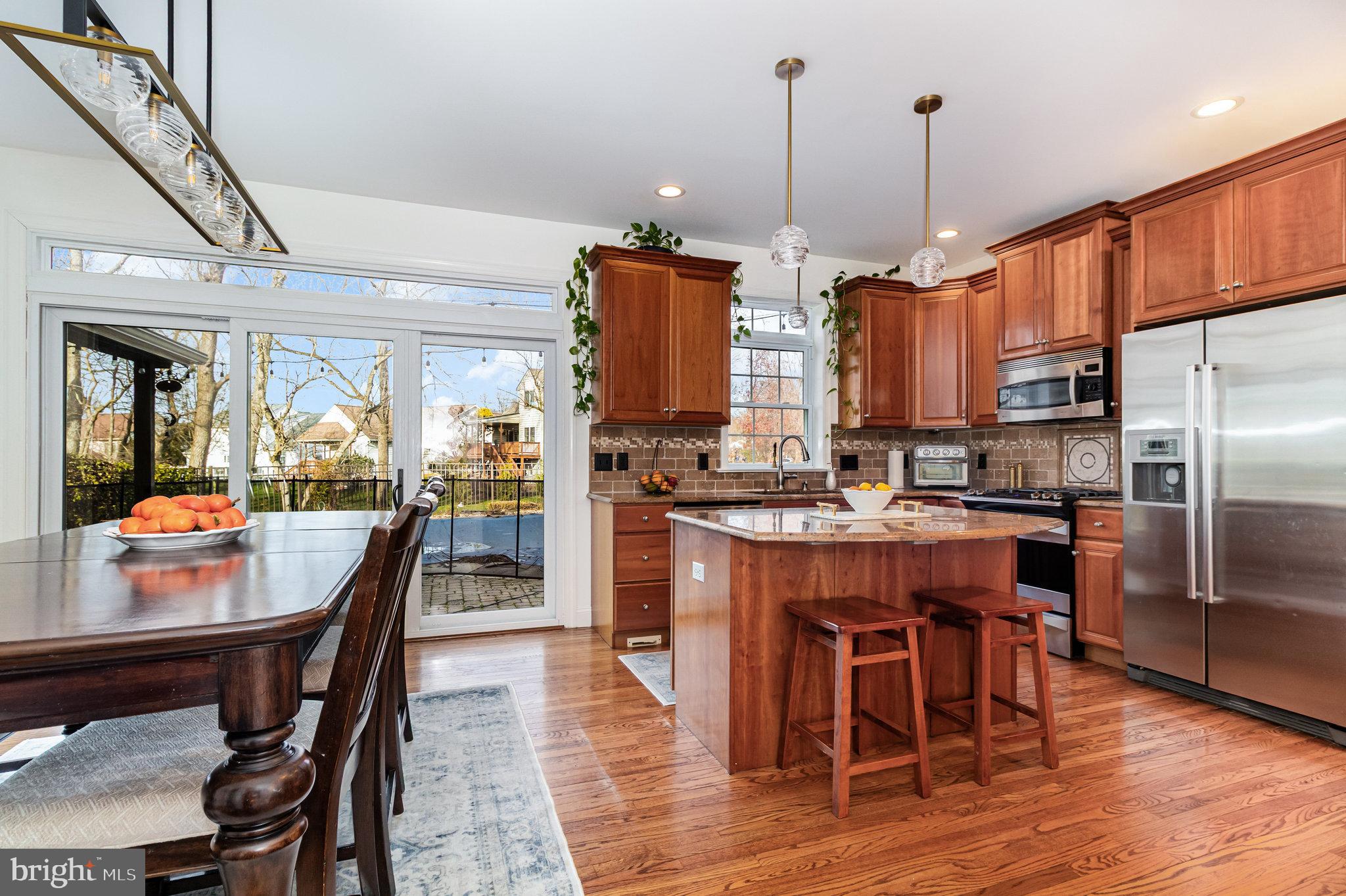123 Glebe Lane Lancaster, PA 17602 - Photo 14 of 57 a kitchen with stainless steel appliances granite countertop a table chairs sink and cabinets
