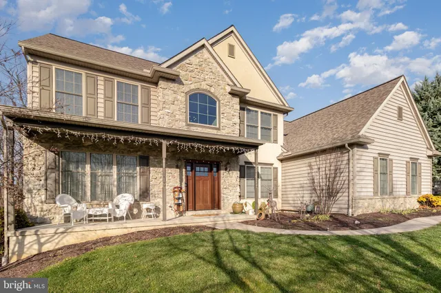 a view of a dining room with furniture a chandelier and wooden floor