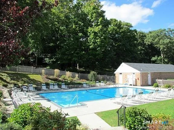 a view of a house with swimming pool and yard