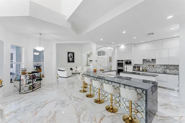 a kitchen with stainless steel appliances a stove a microwave and a refrigerator