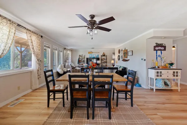 a kitchen with stainless steel appliances granite countertop wooden cabinets a stove a sink and dishwasher with wooden floor