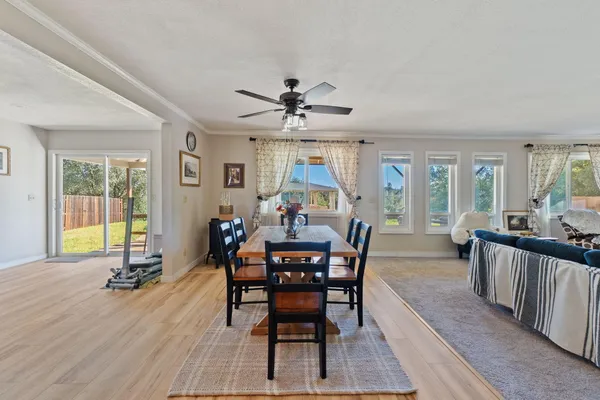 a dining room with furniture window and wooden floor