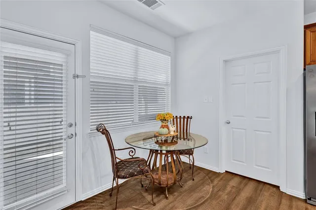 a view of a room with a table and chairs