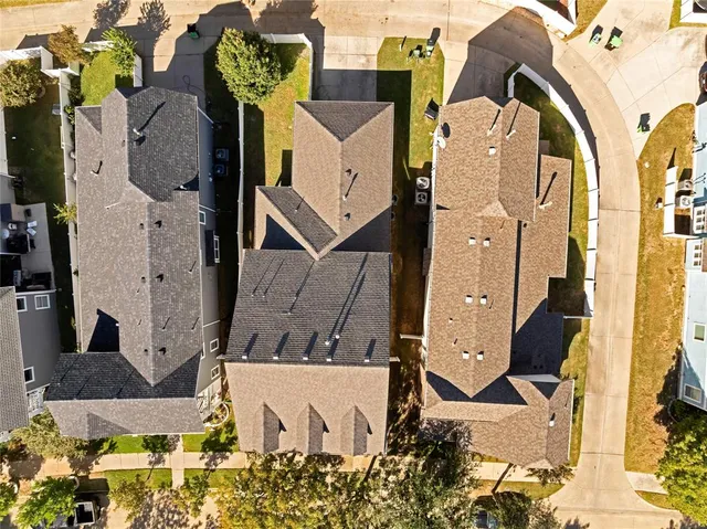 an aerial view of residential houses with outdoor space