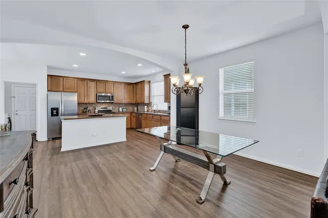 a view of a kitchen with sink microwave and refrigerator