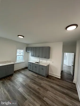 a kitchen with sink cabinets and wooden floor