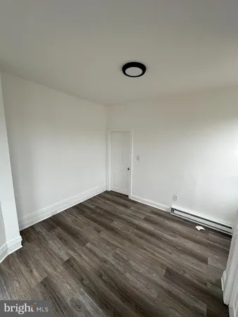 a view of room with wooden floor and window