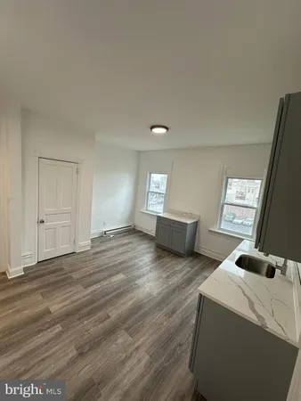 a bedroom with two beds and a computer on desk next to a window
