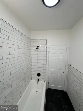 a bathroom with a bathtub and shower