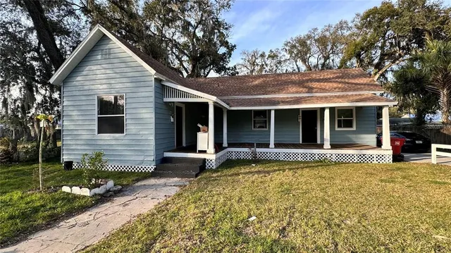 a front view of a house with a garden and porch