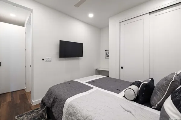 a bathroom with a granite countertop sink a toilet and shower