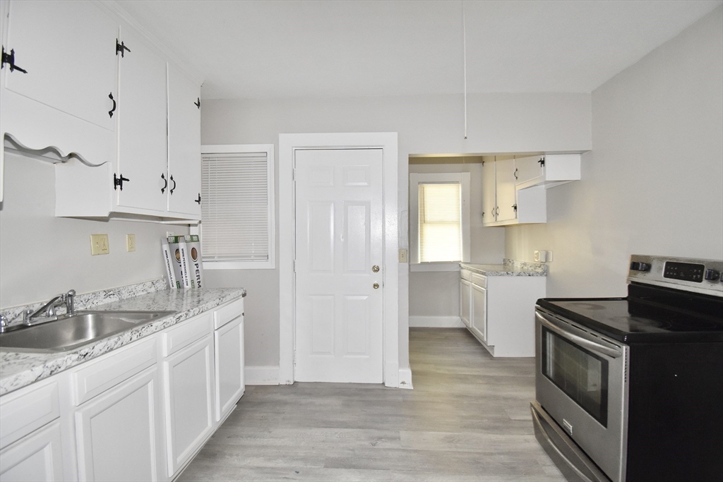30 Sachem Street Springfield, MA 01108 - Photo 21 of 22 a kitchen with white cabinets and sink