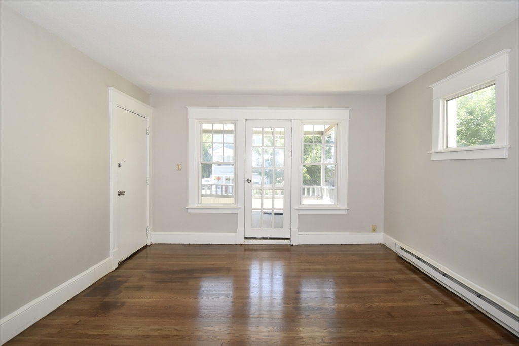 30 Sachem Street Springfield, MA 01108 - Photo 6 of 22 an empty room with wooden floor and windows