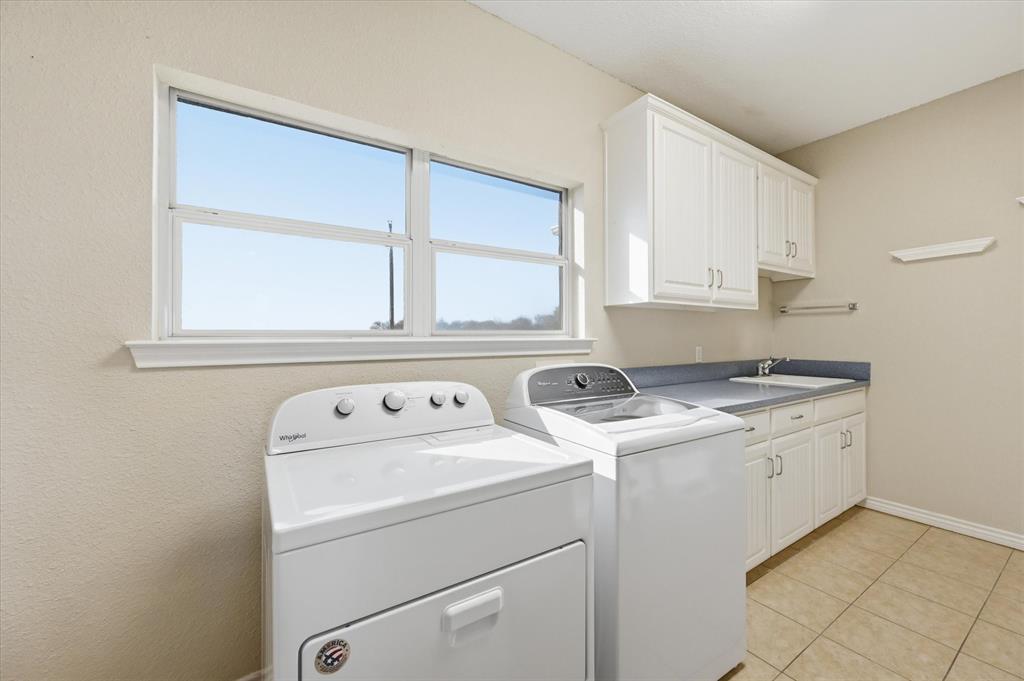 1616 Nash-Howard Road Waxahachie, TX 75165 - Photo 18 of 36 a view of washer and dryer with kitchen in the background