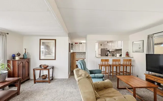 a kitchen with stainless steel appliances granite countertop a sink and a refrigerator