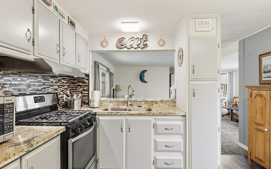 2240 Golden Oak Lane Merced, CA 95340 - Photo 18 of 44 a kitchen with cabinets appliances and a counter space