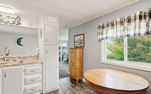 a kitchen with a sink window and cabinets