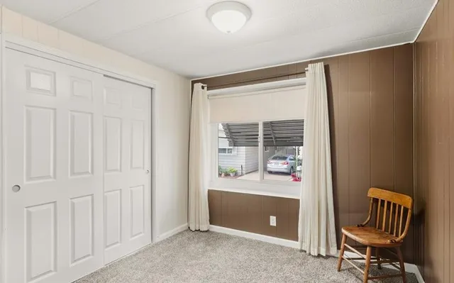 a view of a hallway with closet and front door