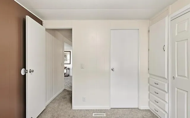 a en suite bathroom with a granite countertop sink and a mirror