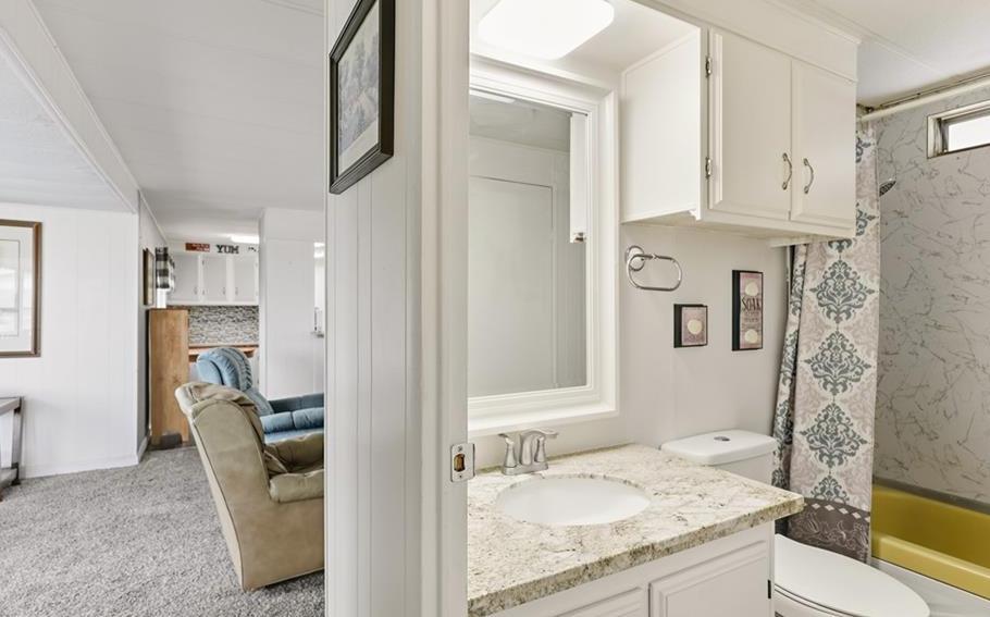 2240 Golden Oak Lane Merced, CA 95340 - Photo 24 of 44 a en suite bathroom with a granite countertop sink and a mirror