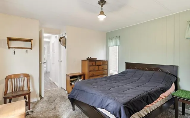 a bathroom with a granite countertop sink a mirror a vanity and a shower