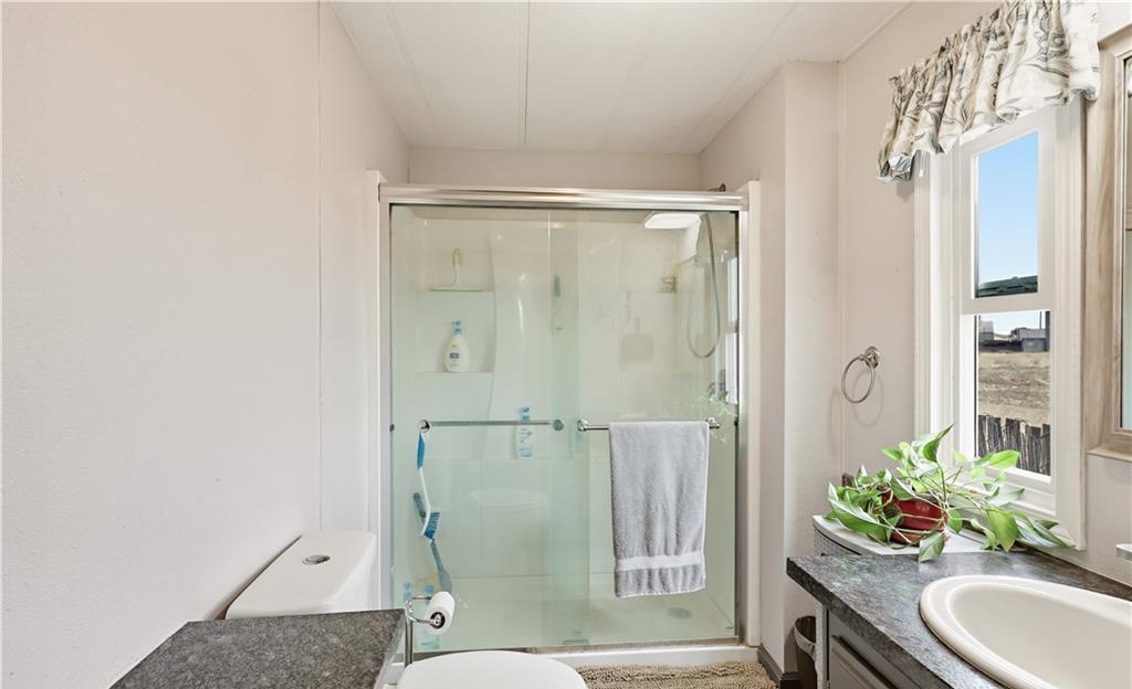2240 Golden Oak Lane Merced, CA 95340 - Photo 29 of 44 a bathroom with a granite countertop sink toilet and shower