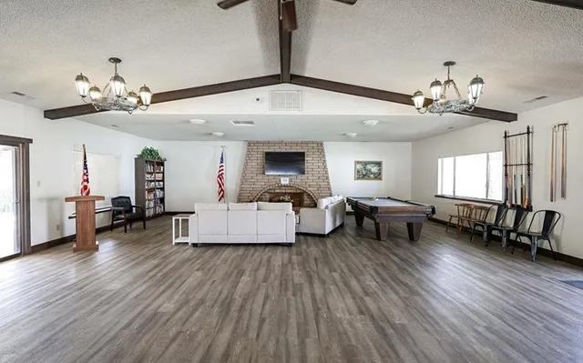 a view of house with swimming pool and furniture