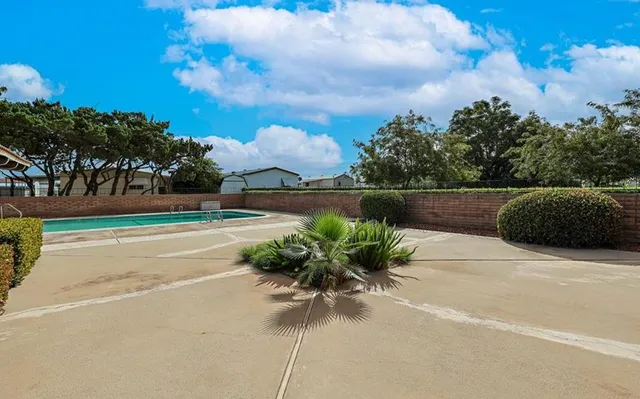 a view of grassy field with benches