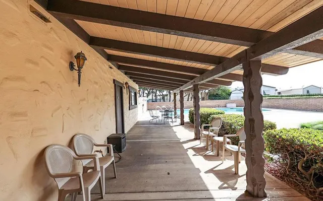 a view of a house with wooden fence