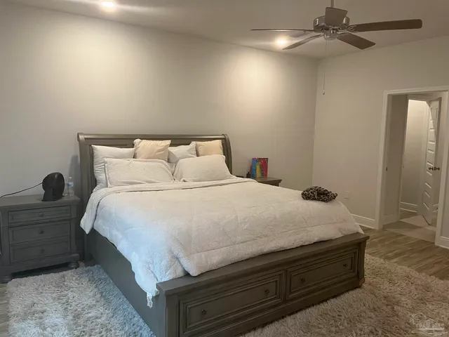 a large bed sitting in a bedroom next to a bathroom