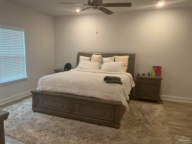 a bedroom with a bed and a window