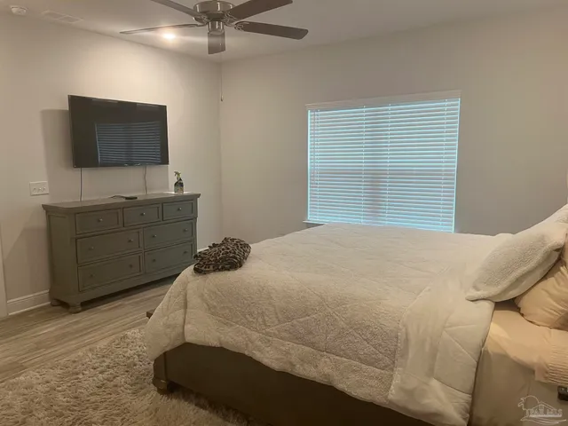 a bedroom with a bed and flat screen tv