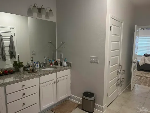 a bathroom with a double vanity sink and a mirror