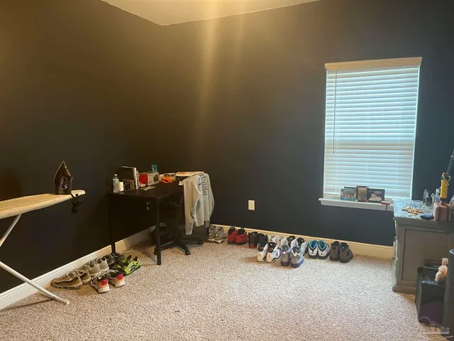 a room with gym equipment and a window