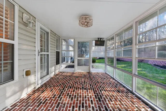 a view of a porch with wooden floor and iron fence