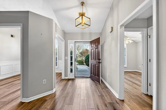 a view of a hallway view with wooden floor and staircase