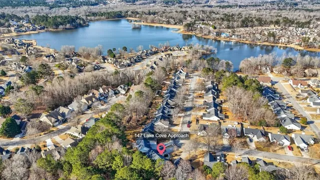 an aerial view of house with yard and lake view
