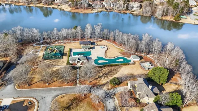 an aerial view of a house with a lake view