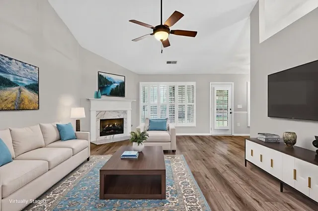 a living room with furniture fireplace and flat screen tv