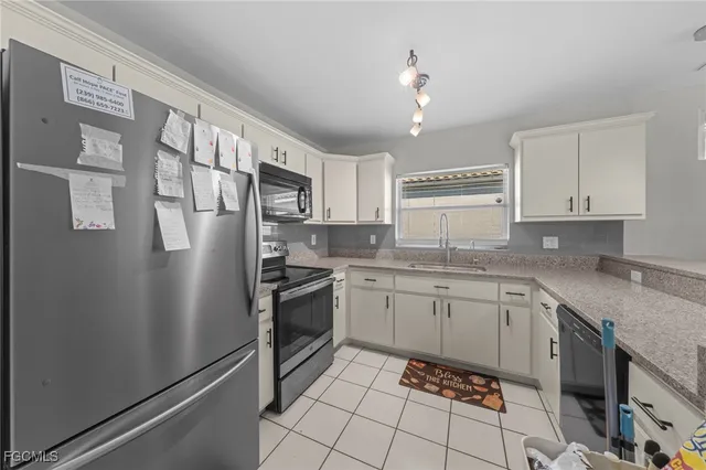 a kitchen with a sink cabinets and window