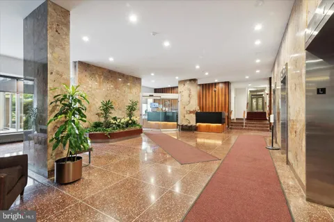 a view of a lobby with black carpet