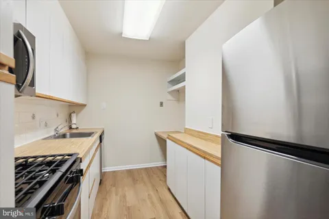 a kitchen with a stove and a microwave