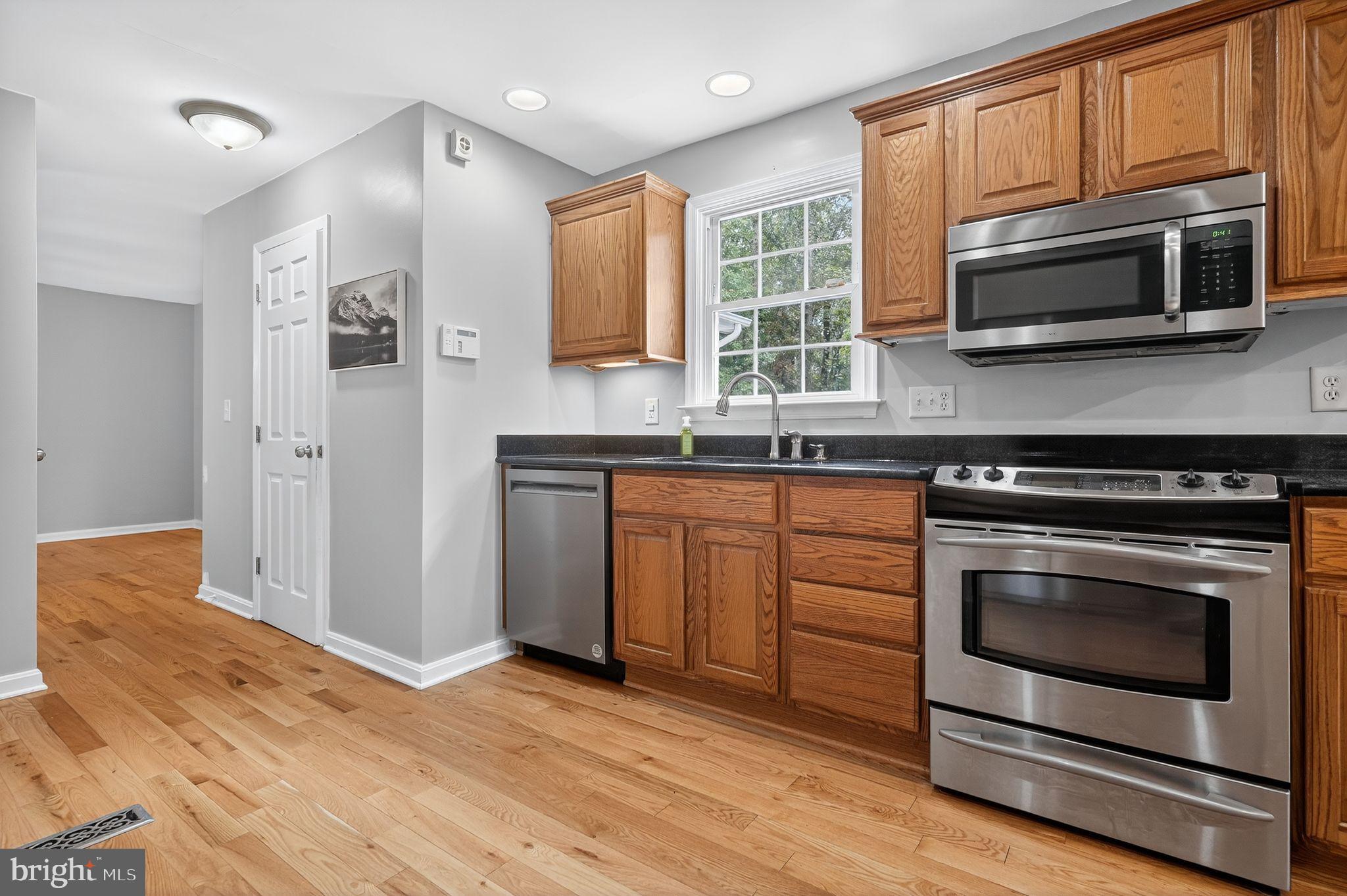 2196 Hallmark Court Gambrills, MD 21054 - Photo 4 of 14 a kitchen with stainless steel appliances granite countertop a stove microwave and refrigerator