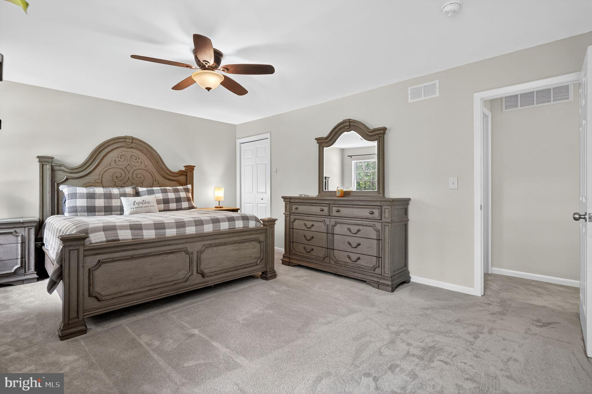 2196 Hallmark Court Gambrills, MD 21054 - Photo 7 of 14 a spacious bedroom with a bed and a dresser