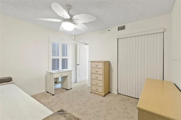 an empty room with windows and closet