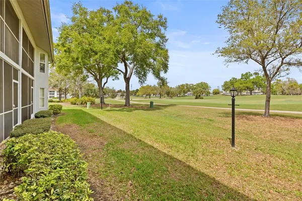 a view of yard with swimming pool and green space