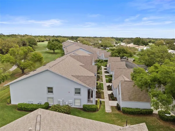 an aerial view of a house with a yard and lake view